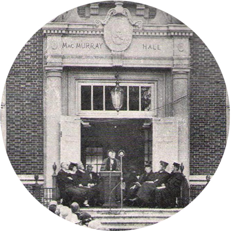 Jane Addams speaking on the steps of MacMurray Hall surrounded by dignitaries