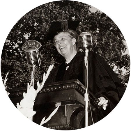 Eleanor Roosevelt standing at a podium speaking into a WLDS microphone. 